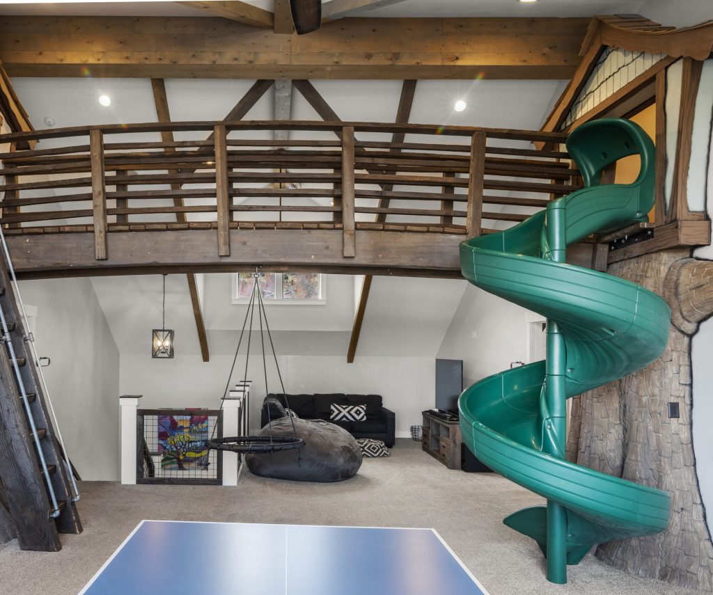 Tree-house loft with green spiral slide at Patagonia Lodge
